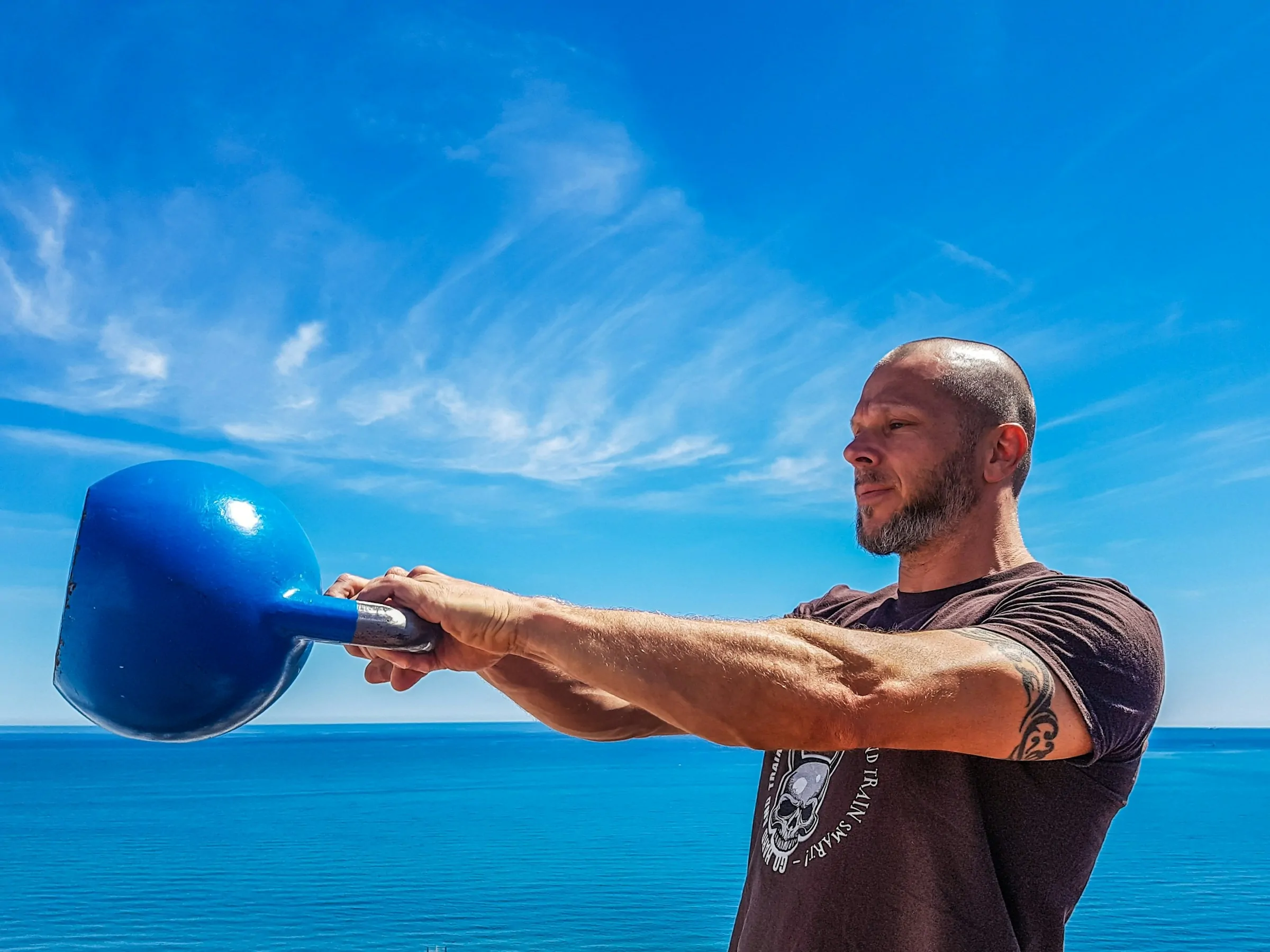 man using a kettlebell - Strength Training Program